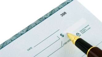 Someone prepares to write a check | ID 5985610 © Py2000 | Dreamstime.com