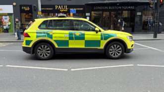 An SUV bearing the design and logos of the National Health Service (NHS), on a London street. | Jarretera | Dreamstime.com