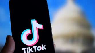 A smartphone displaying the TikTok logo, with the U.S. Capitol Building in the background. | Cfoto/ZUMAPRESS/Newscom