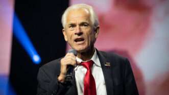 Peter Navarro speaks on stage while holding a microphone | Robin Rayne/ZUMAPRESS/Newscom