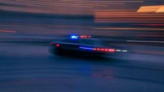 A police car during a chase | Photo by <a href="https://unsplash.com/@abject?utm_content=creditCopyText&utm_medium=referral&utm_source=unsplash">benjamin lehman</a> on <a href="https://unsplash.com/photos/a-police-car-driving-down-a-street-at-night-eqkdWtwct64?utm_content=creditCopyText&utm_medium=referral&utm_source=unsplash">Unsplash</a>       