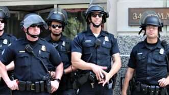 Several police officers standing in a line, with riot helmets. | Madisonmuskopf | Dreamstime.com