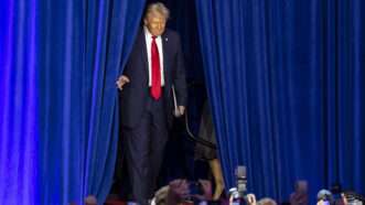 President-elect Donald Trump emerges from behind a blue curtain to greet supporters. | Matias J. Ocner/TNS/Newscom