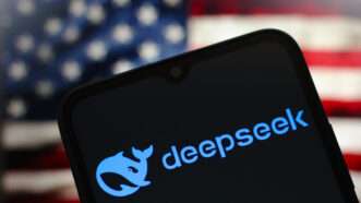 Smartphone displays DeepSeek logo in front of an American flag. | Thomas Fuller / SOPA Images/Sipa USA/Newscom