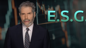 John Stossel is seen next to a sign that says "E.S.G." | Stossel TV