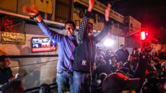 Palestinians react to news of a ceasefire agreement with Israel along a street in Khan Yunis in the southern Gaza Strip. January 15, 2025. | Anas Deeb/UPI/Newscom