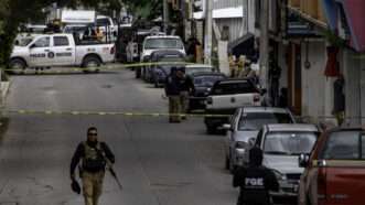 Mexican police officers and investigators fill the streets after an attack in Chilpancingo, Guerrero, Mexico. | David Juarez/ZUMAPRESS/Newscom