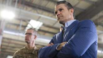 Defense Secretary Pete Hegseth in Poland stands next to a servicemember in uniform | Polaris/Newscom