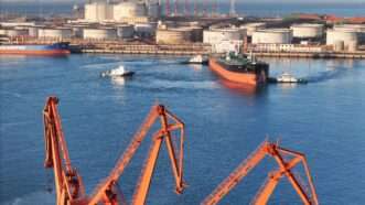 Tugboats assist an oil tanker leaving the pier at a sea port in Longkou in east China's Shandong province Sunday, Dec. 22, 2024. | TANG KE/FEATURECHINA/Newscom