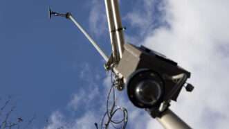 Looking up on a ShotSpotter device atop a light pole, with a surveillance camera pointing down and a microphone device pointed out. | Brian Cassella/TNS/Newscom