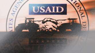 The USAID logo in the background with a sketch of a handshake in the foreground | Illustration: Lex Villena; Midjourney