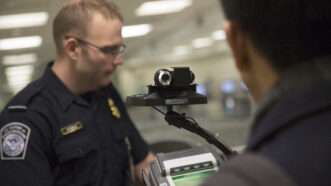 U.S. Customs and Border Protection officers screen international passengers in an illustrative photo. | U.S. Customs and Border Protection Photo by Glenn Fawcett