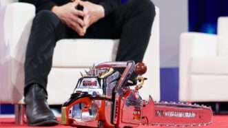 The chainsaw gifted to Elon Musk by Argentinian President Javier Milei, sitting at Musk's feet on the stage at the Conservative Political Action Conference. | Will Oliver - Pool via CNP/Newscom