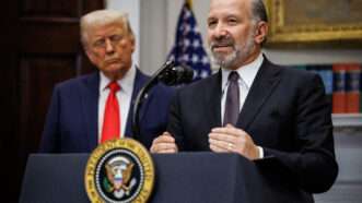 Commerce Secretary Howard Lutnick speaking with President Donald Trump looking on | Samuel Corum - Pool via CNP/CNP / Polaris/Newscom