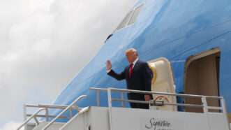 Donald Trump waving from the stairs of Air Force One. | Pedro Portal/TNS/Newscom