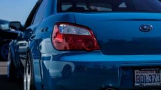 A blue Subaru vehicle as seen from behind | Photo by sgcdesignco on Unsplash