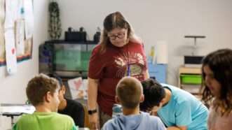 Teacher and students in a school | Jefferee Woo/ZUMA Press/Newscom