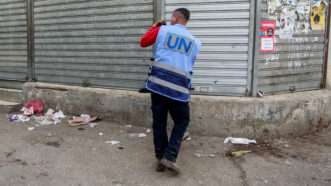 Someone with a United Nations vest is seen taking a photo of the closed Palestinian shops during a general strike in the West Bank. Apr 7, 2025. | Nasser Ishtayeh/ZUMAPRESS/Newscom