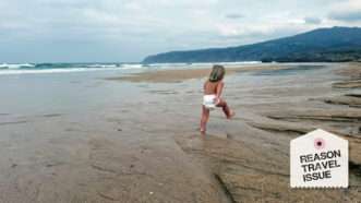 A small child walks along a beach | Photo: Courtesy of Liz Wolfe