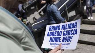 A protester holds a sign that says "Bring Kilmar Abrego Garcia home now!" | Gina M Randazzo/ZUMAPRESS/Newscom