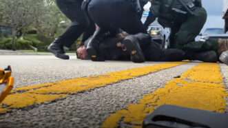 Still from a video showing immigration officers arresting a man | The Guardian