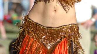 A belly dancer's exposed midriff. | Patrick Bronson | Dreamstime.com