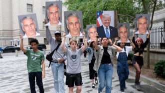 Protestors holding signs of Jeffrey Epstein and Donald Trump | Luiz C. Ribeiro/TNS/Newscom