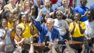 Gov. Greg Abbott surrounded by children at a bill signing. | Bob Daemmrich/ZUMAPRESS/Newscom