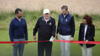Donald Trump cutting a ribbon at a golf course | HUGO PHILPOTT/UPI/Newscom