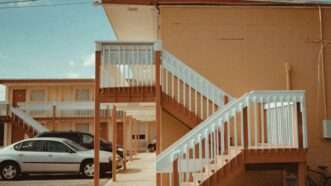 Motel | Photo by <a href="https://unsplash.com/@caviking101?utm_content=creditCopyText&utm_medium=referral&utm_source=unsplash">Andrew Karn</a> on <a href="https://unsplash.com/photos/two-vehicles-parked-in-front-of-establishment--yZjegM0sUw?utm_content=creditCopyText&utm_medium=referral&utm_source=unsplash">Unsplash</a>       