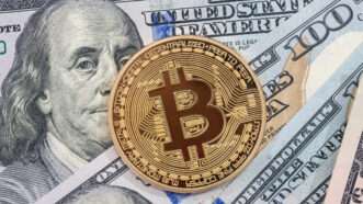 A bitcoin against U.S. currency | ID 104142472 | Dollar ©  Roman Romaniuk | Dreamstime.com
