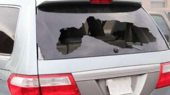An SUV's broken rear window. | Bill Mc Keon | Dreamstime.com