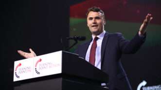 Charlie Kirk speaks at a political event behind a lectern with Turning Point USA logos. | Gage Skidmore/ZUMAPRESS/Newscom