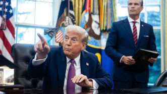 Trump sits in the Oval Office with Pete Hegseth standing behind him | Francis Chung - Pool via CNP/CNP / Polaris/Newscom