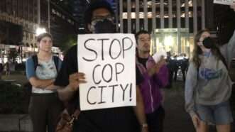 A protester holds up a sign that says "Stop Cop City." | Niyi Fote/ZUMAPRESS/Newscom