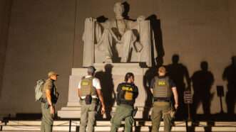 DEA agents standing around the Lincoln Memorial | Photo: Alex Kent/The Washington Post/Getty Images