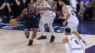 Kawhi Leonard with a basketball in motion, with three players on the Denver Nuggets also in frame. | Ariana Ruiz/ZUMAPRESS/Newscom