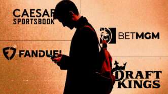 A man wearing a backpack stares down at his phone in his hands—he's superimposed over an orange background and the logos for Caesars Sportsbook, BetMGM, DraftKings, and FanDuel. | Illustration: Eddie Marshall | Midjourney