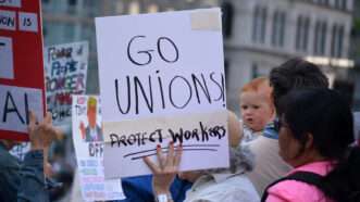 A protest sign reading "Go Unions" | ID 379318757 ©  Cpenler | Dreamstime.com