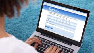 Someone takes a survey on a laptop | Andrey Popov/Dreamstime.com
