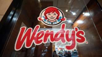 A Wendy's logo on a store window | Anthony Behar/Sipa USA/Newscom