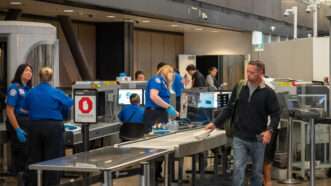 A man passes through a Transportation Security Administration (TSA) airport security checkpoint. | David Tran | Dreamstime.com