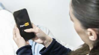 Woman on smartphone pulling up Pornhub | AnneLyse Lecuyer/ZUMAPRESS/Newscom