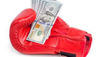 A boxing glove with a handful of U.S. 0 bills. | Zaclurs | Dreamstime.com