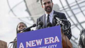 New York City Mayor-elect Zohran Mamdani addresses a crowd, behind a campaign sign that says "A New Era for New York City." | Andrew Schwartz/SIPA/Newscom
