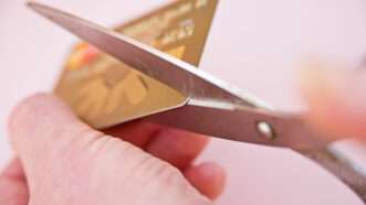 Someone cuts up a credit card | ID <a href="https://www.dreamstime.com/royalty-free-stock-images-reducing-debt-cutting-up-credit-card-image16937049">16937049</a> ©  <a href="https://www.dreamstime.com/davidwatmough_info">Ayome Watmough</a> | <a href="https://www.dreamstime.com/">Dreamstime.com</a>
