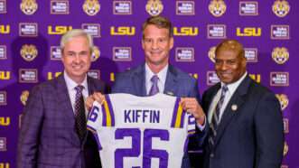 Lane Kiffin holding an LSU jersey | Jonathan Mailhes/Cal Sport Media/Newscom