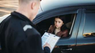 Woman pulled over by police | ID 122413933 | Traffic Control ©  Nomadsoul1 | Dreamstime.com