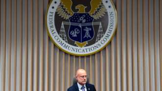 Brendan Carr sitting beneath the FCC seal | Photo: Federal Communications Commission Chairman Brendan Carr; Kent Nishimura/Bloomberg/Getty