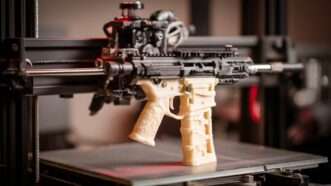 A semiautomatic rifle akin to the AR-15 being printed by a 3D printer. | Midjourney